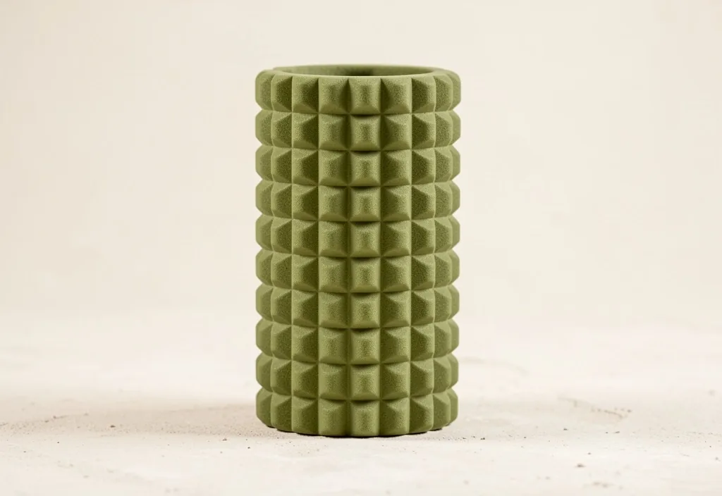 High-density textured foam roller standing upright in studio light